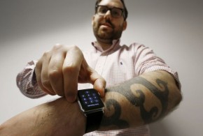 Reuters journalist Matt Siegel inputs his passcode onto his Apple Watch as his tattoos prevent the device's sensors from correctly detecting his skin, in Sydney